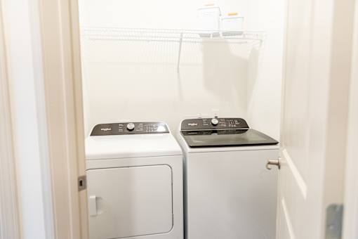 Laundry room with stacked washer and dryer at The Crest at Acworth Apartments, Acworth, 30102
