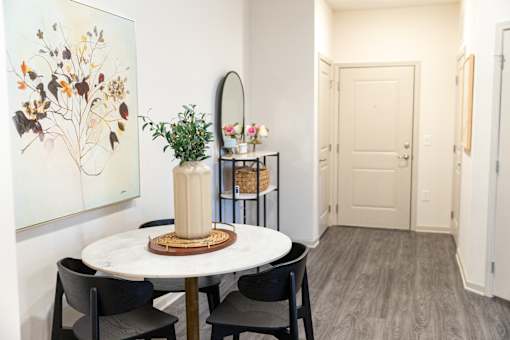 Dining area with round table and floral artwork at The Crest at Acworth Apartments, Acworth, 30102