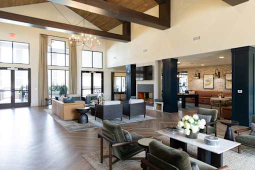 A large, open living room with wooden floors and furniture.