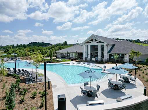 A large outdoor swimming pool with a building in the background.