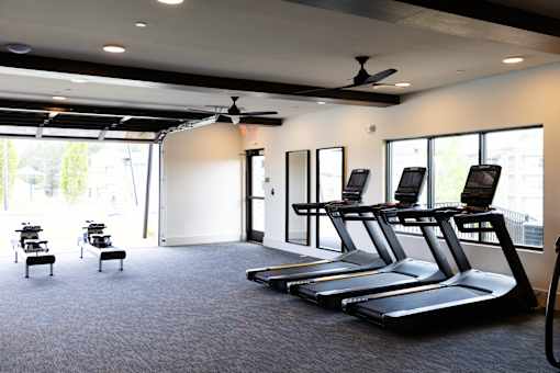 A gym with treadmills and exercise equipment.