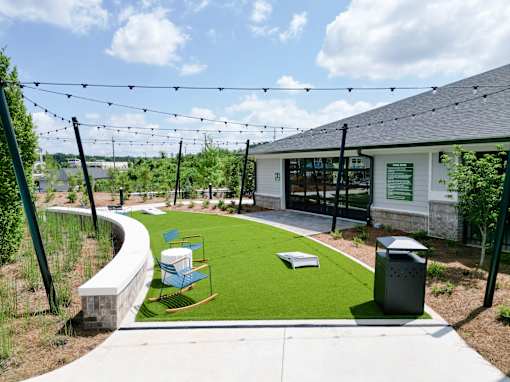 A playground area with a slide and a green lawn.