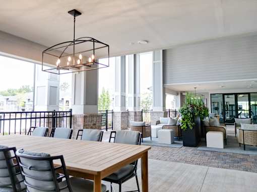 A modern dining area with a long wooden table and chairs.