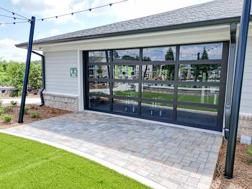 A building with a glass door and a sign on the wall.
