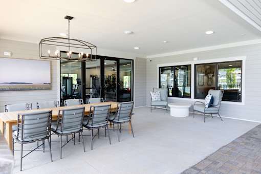 A modern dining room with a large table and chairs.