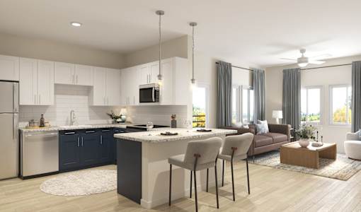 A modern kitchen with a large island and a dining area.