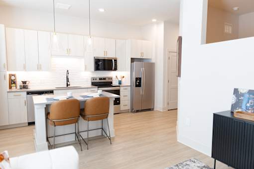 Bright minimalist kitchen with Table and Chairs at District on the Etowah Apartments, Canton, GA