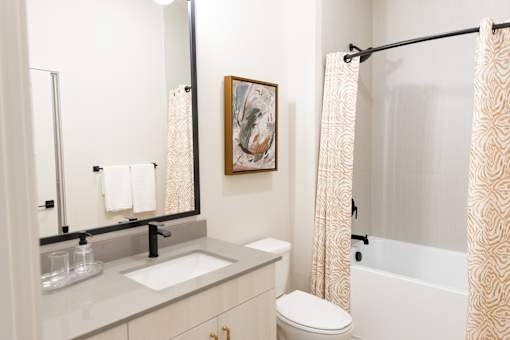Radiant bathroom with bright mirror light at District on the Etowah Apartments, Georgia