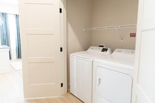 Two machines in opened door laundry at District on the Etowah Apartments, Canton Georgia