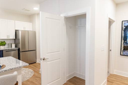 Kitchen with white cabinets and a refrigerator at The Crest at Oakwood, Oakwood