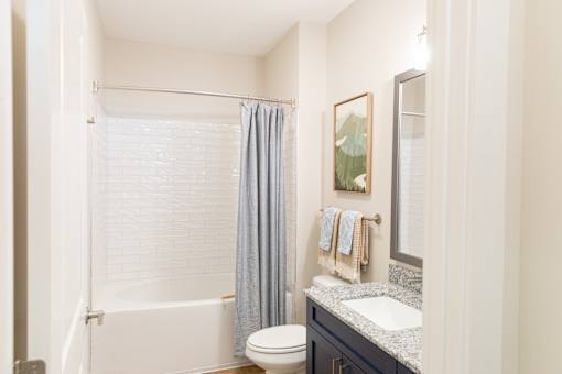 Bathroom with toilet and bathtub at The Crest at Oakwood, Oakwood, Georgia