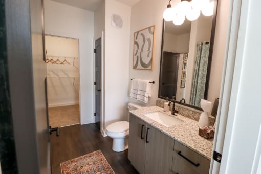 The Wren 1 bedroom model apartment home bathroom with granite countertop vanity located in Lawrenceville, GA