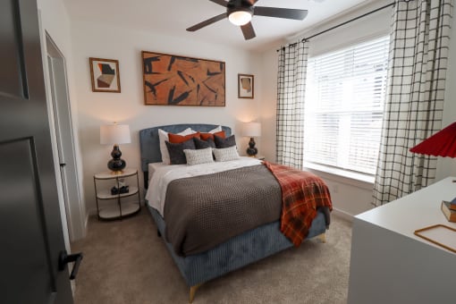 The Wren 1 bedroom model apartment home bedroom with ceiling fan located in Lawrenceville, GA
