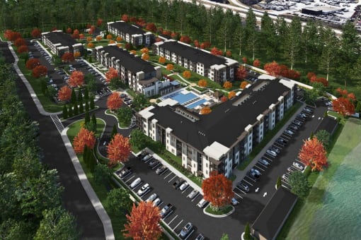 an aerial view of a development of townhomes with cars parked on the side of the