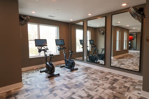 The Wren Fitness Studio yoga room with exercise bikes and large mirrors located in Lawrenceville,GA