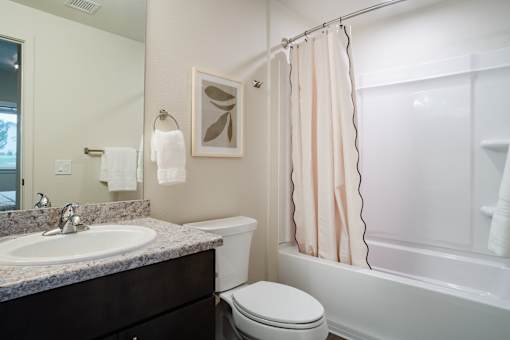 A white toilet sits next to a sink in a bathroom.