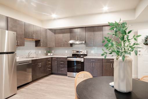 A modern kitchen with a table and chairs.
