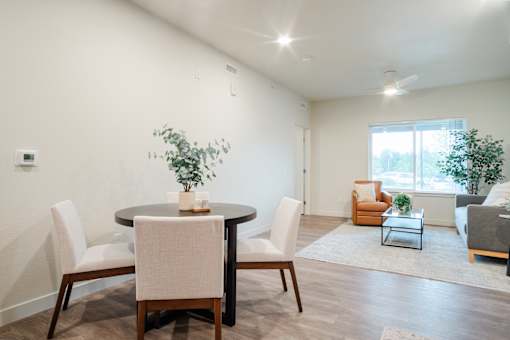 A dining room with a table and chairs.