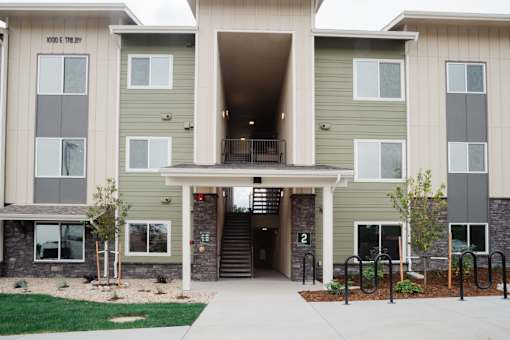 A building with a green and beige exterior and a number 2 on the front.