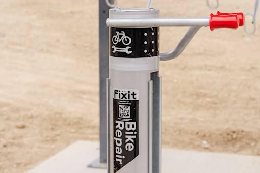 A bike repair kit is attached to a bike handlebar.