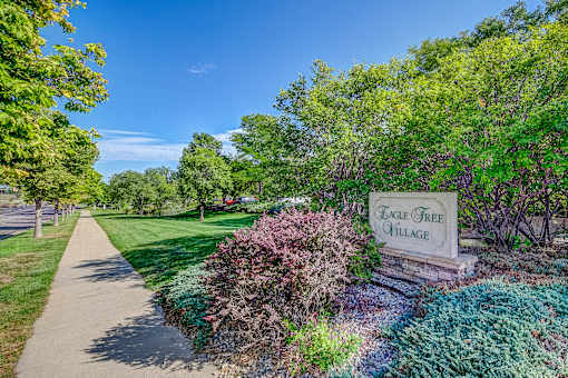 a park with a sidewalk and a sign that reads beach area alliance