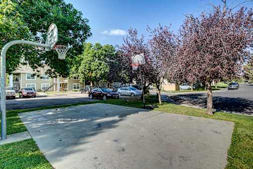 a basketball hoop at the corner of a street