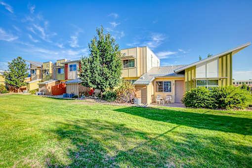 a row of houses with a lawn in front of them