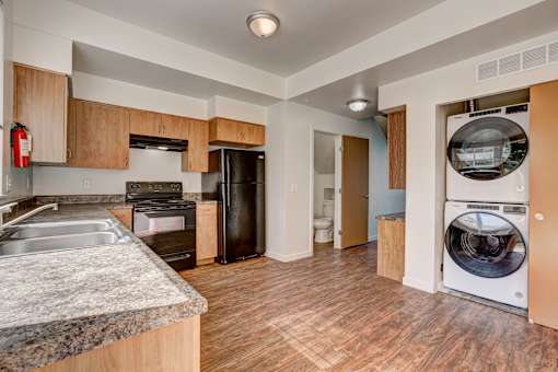 a kitchen with a washing machine and a washer and dryer