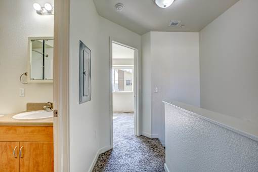 an empty bathroom with a sink and a mirror in a house