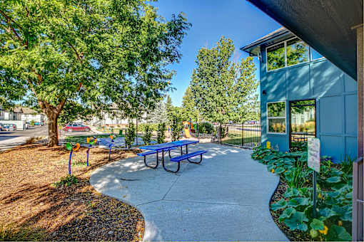 a blue picnic table and bench outside of a building