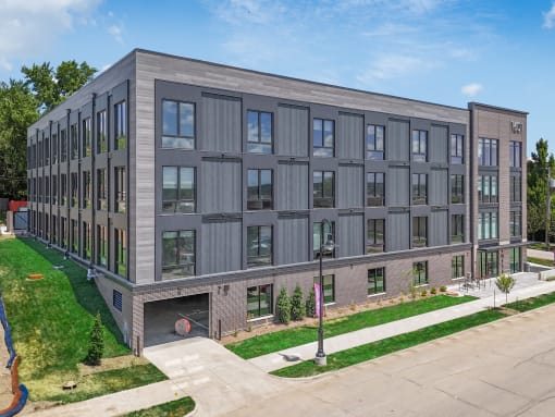 a new apartment building on the corner of a sidewalk