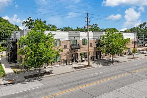 A street view of a building with a yellow line in the middle of the road.