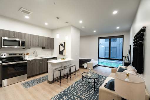 A modern kitchen with a dining table and chairs.