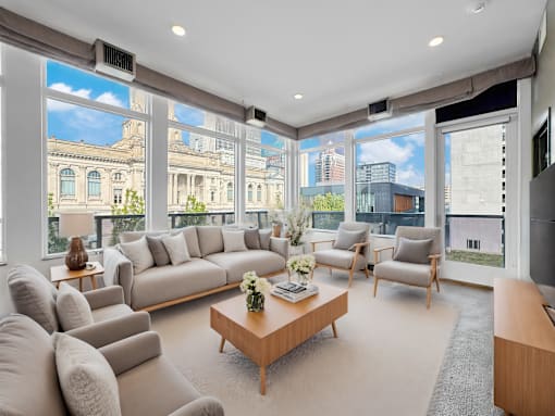 A living room with a large window overlooking a cityscape.