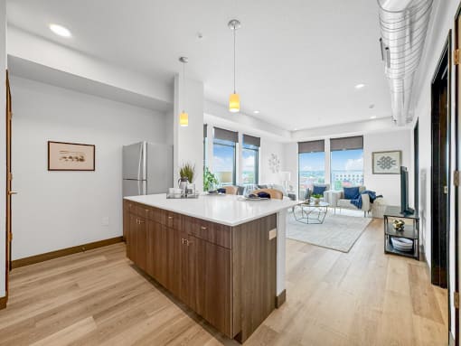 a kitchen with a large island and a living room