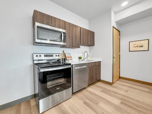 a kitchen with stainless steel appliances and a microwave
