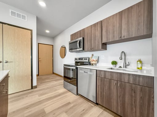 a kitchen with stainless steel appliances and wooden cabinets