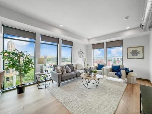 a living room with large windows and a rug