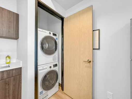 a small laundry room with a washer and dryer in a door