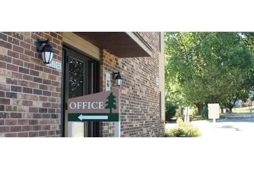 A sign on a building that says "Office" with a tree symbol.