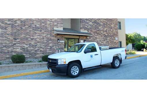 A white pickup truck is parked on the side of a street.
