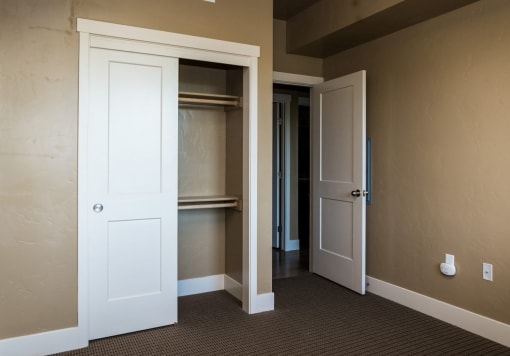 Bedroom with open doors and a closet