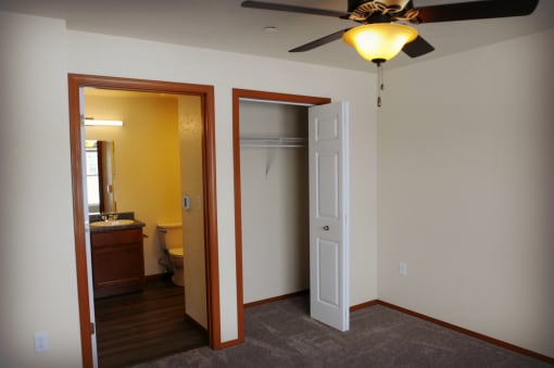 Image showing toile and bathroom sink next to closet with hanger racks