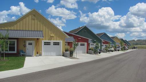 A row of units with a road in front.