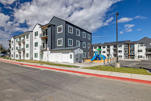 Apartment buildings with a playground in front.