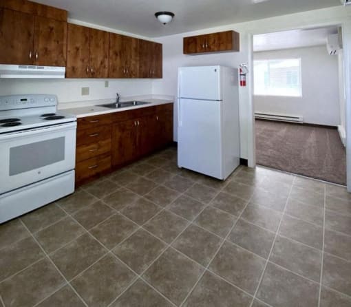 a kitchen with a white refrigerator and a stove
