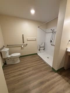 A bathroom with a toilet, sink, and shower.