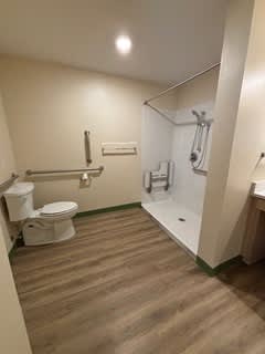 A bathroom with a toilet, sink, and shower.