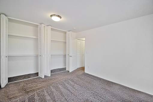 Spacious apartment bedroom with large closets at Huntington Club Apartments in Warren, Michigan