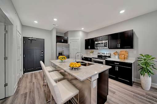 A modern kitchen with a dining table and chairs.